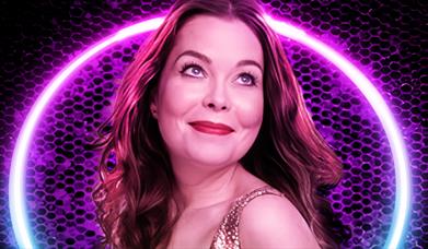 Juliette Burton in a halo in front of a colour glittery background