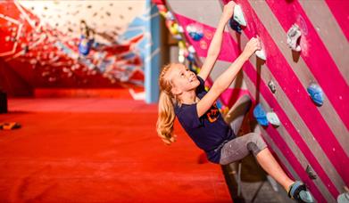 Children climbing boulders wall