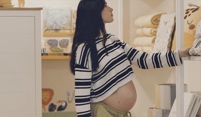 Pregnant person looking at shelves