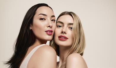 Two model close up showcasing clarins lip oil