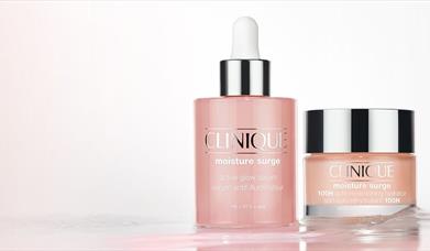 Clinique moisture surge serum bottle next to clinique moisture surge bottl
