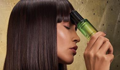 Model holding an aveda product