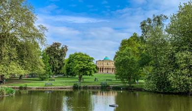 Pittville Pump Room Cheltenham across the lake