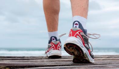 A pair of feet in trainers